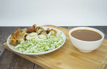 Indian Rojak with fried shrimp fritters, tofu, egg, shredded cucumber and turnip with sweet and spicy peanut gravy. Popular street food in Malaysia. Selective focus points. Blurred backgroundの写真素材