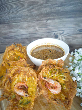 Fried prawn fritters or commonly known as cucur udang served with spicy peanut sauce. Selective...
