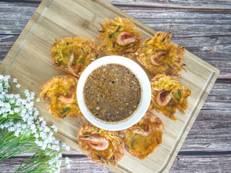 Fried prawn fritters or commonly known as cucur udang served with spicy peanut sauce. Selective focus points. Blurred backgroundの写真素材