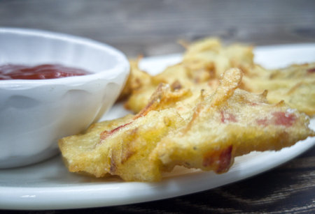 Anchovies fritters or locally known as cucur bilis with chilli sauce dip. Selective focus points. Blurred backgroundの写真素材