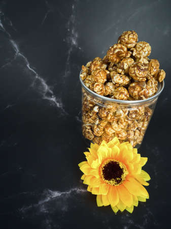 A jar full full of popcorn. Delicious partner when watching movies. Selective focus pointsの写真素材