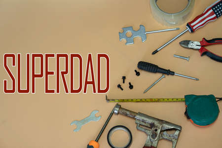 Happy Father's Day concept with used construction tools and text. Selective focus points