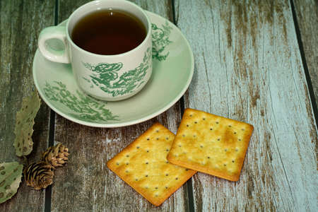Breakfast serving of cream crackers and a cup of tea. Selective focus points. Blurred backgroundの写真素材