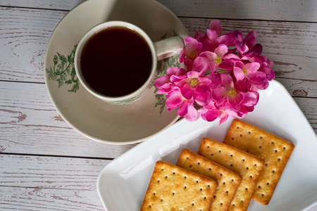 Breakfast serving of cream crackers and a cup of tea. Selective focus points. Blurred backgroundの写真素材