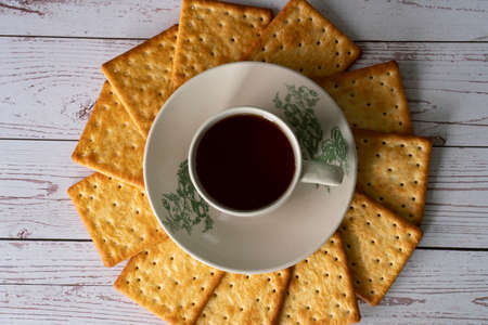Breakfast serving of cream crackers and a cup of tea. Selective focus points. Blurred backgroundの写真素材