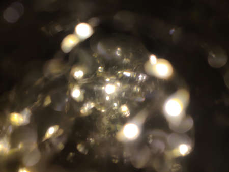 Close-up of the white fairy lights inside a globe. Selective focus points with bokeh effect.