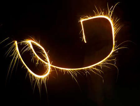 Motion blur effect from playing the sparklers sticks at night.の写真素材