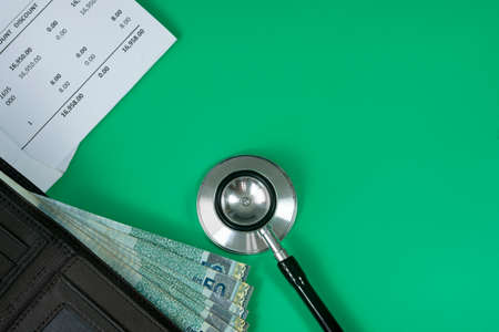 Medical and business concept. Layout of stethoscope, medical bills and wallet with cash. Selective...