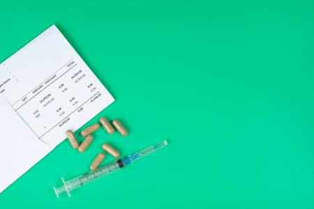 Medical and business concept. Layout of medical bills, syringe and pills. Selective focus pointsの写真素材