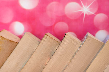 Close-up of a stack of books arranged slanted side by side. Selective focus points. Blurred backgroundの写真素材