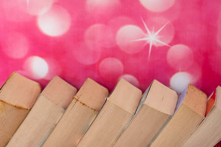Close-up of a stack of books arranged slanted side by side. Selective focus points. Blurred backgroundの写真素材