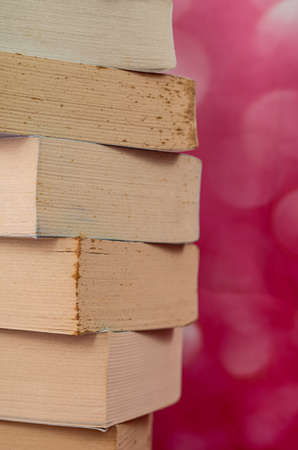 Close-up of a stack of books on top of each other. Selective focus points. Blurred backgroundの写真素材