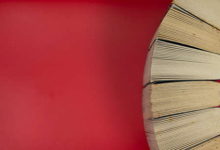 Close-up of a stack of books side by side from top view. Selective focus points. Blurred backgroundの写真素材