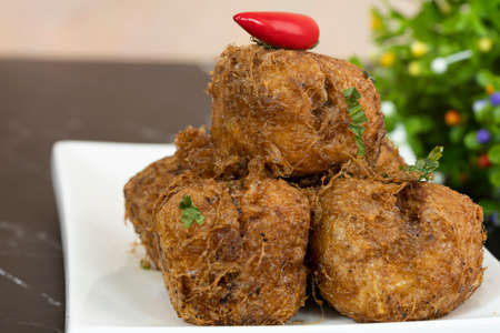 A serving of tauhu bergedil, a famous Malaysian dish with spicy soy sauce as dips. Blurred backgroundの写真素材