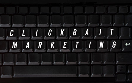 Close-up of a keyboard with blank keys and text Clickbait Marketing. Clickbait is a method to entice user to click a post in the internetの写真素材