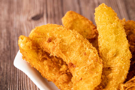 Close-up of freshly cooked fried bananas. Selective focus points. Blurred background.の写真素材