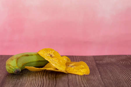 Banana chip or locally known as kerepek pisang with raw young banana. Selective focus points. Blurred backgroundの写真素材