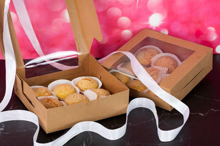 A tray full of Japanese Cream Puff with the delivery box and loose white ribbon. Selective focus points. Blurred backgroundの写真素材