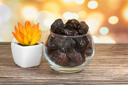 A bowl of Safawi dates, popular during fasting month. Selective focus points. Blurred background