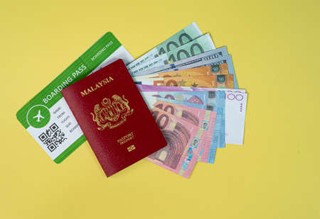 Vacation concept. Layout of passport, boarding pass and fake money. People are ready to go for...