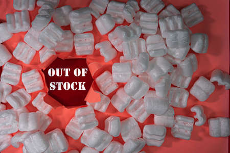Business concept. Layout of packing peanuts, torn paper with text OUT OF STOCK.の写真素材
