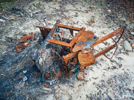 Burnt and rusted massage chair on white sandの写真素材