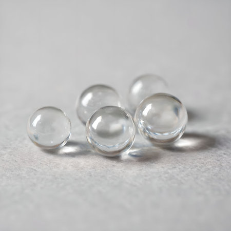 Macro shot of a group of transparent glass balls on white backgroundの素材