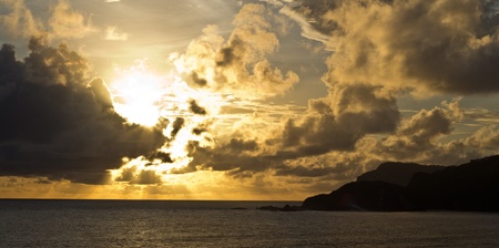The sun sets behind the clouds in Kuta Lombok, Indonesia の写真素材