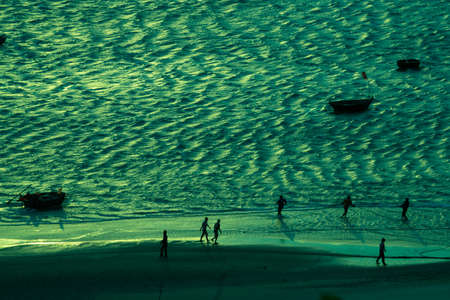 Fishermans and boats on the beachの写真素材