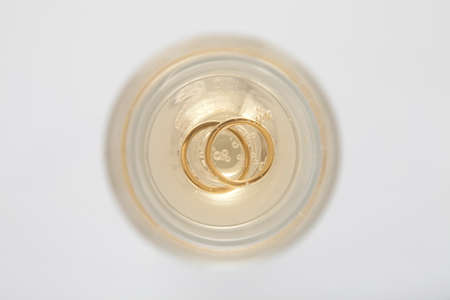 Two champagne glasses with a wedding bouquet