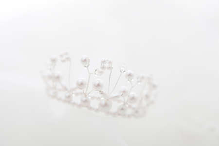 A close up of a wedding crown on silkの写真素材