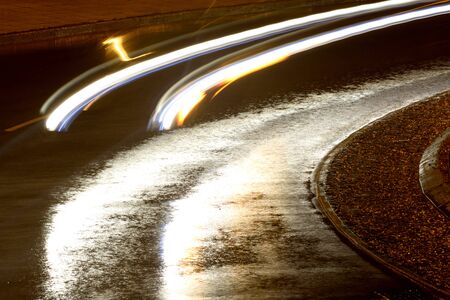 Car motion lights on a rainy nightの写真素材