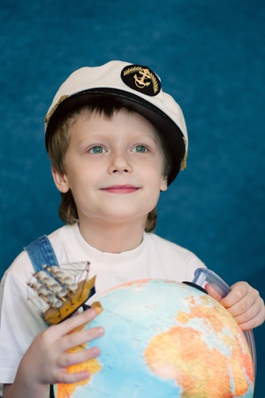 cute dreaming child with the globe modelの写真素材