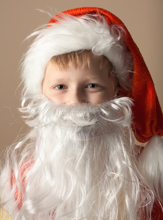 Little boy in Santa Claus suit with beardの写真素材