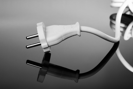 Abstract white europe standard power plug over black background