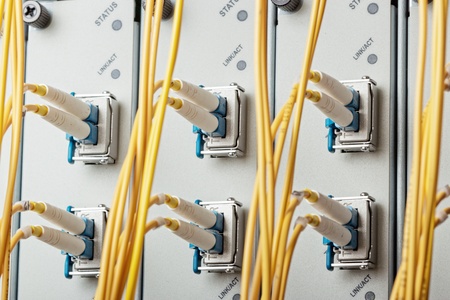 Modern internet router in data center with 10G interface cards, XFP modules and single mode fiber...