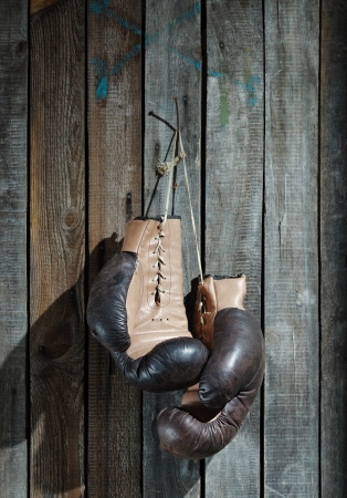 Brown old boxing gloves wooden wallの写真素材