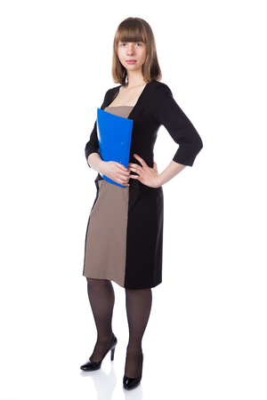 Woman with folder in casual business suit stand isolated over white background.の写真素材