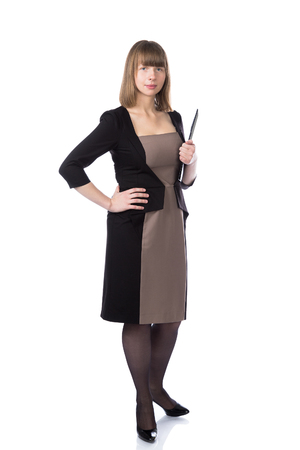 Woman with folder in casual business suit stand isolated over white background.の写真素材