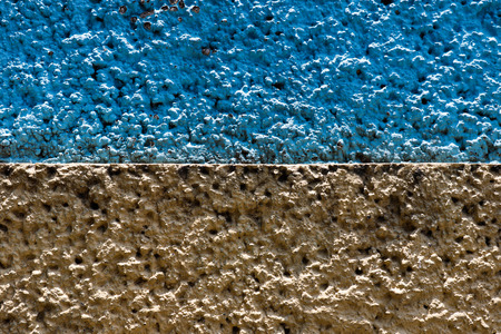 Blue and ochre wall textureの写真素材
