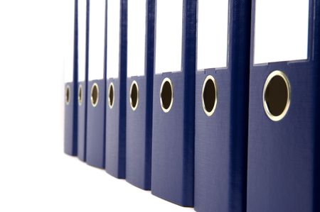 row of blue ring binders with blank labels on whiteの写真素材