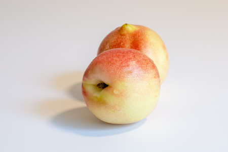 Two beautiful juicy bright yellow nectarines lie side by side. Beautiful fruits. Proper nutrition....