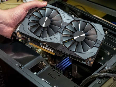 Installing video card in an open case of personal computer. Graphics adapter or graphics card in the...