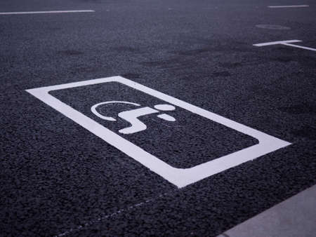 New disabled person sign painted on the new asphalt. Closeup viewの写真素材