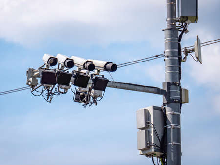 Road speed control cameras on the background of blue sky. Construction on the poleの写真素材
