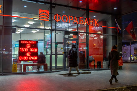 Course of the American Dollar and Euro to Russian Ruble. Electronic board with currency exchange rates in the window of the Russian bank Forabank. Russia, Moscow, March 19, 2020のeditorial素材