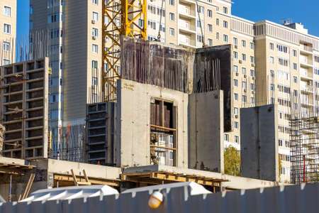 Removing the aluminum formwork from the new concrete wall with a crane. Construction of a high-rise...