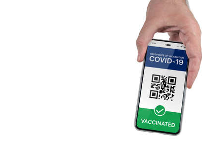 A mans hand holds a mobile phone with a valid QR code of vaccination against coronavirus infection COVID-19. Digital certificate of vaccination. Isolated on white background, copy spaceの写真素材