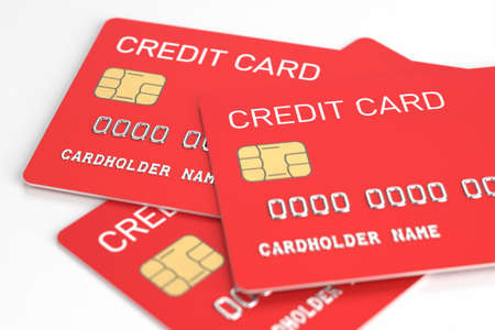 Red plastic credit cards on a white table. Banking and e-commerce concept. Dummy bank card without...