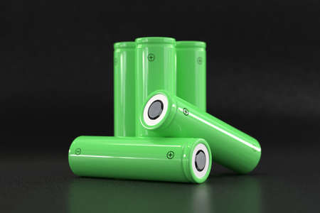 5 green cylindrical batteries on a black background. Storage battery or secondary cell. Rechargeable li-ion batteries for electrical appliances and devicesの写真素材